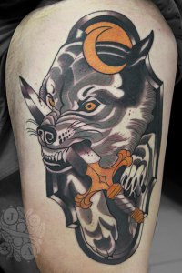 large wolf biting sword on side tattoo by justin acca