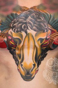 By Justin Acca rams head chest tattoo
