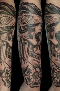 black sideview skull with bandana and flowers tattoo by Justin Acca
